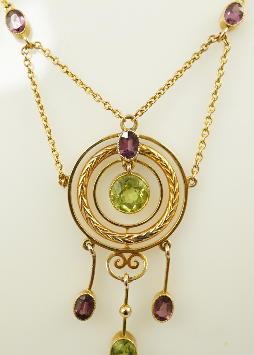 An Edwardian 9ct gold, peridot and garnet set drop pendant necklace, by Murrle Bennett & Co